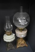 A Victorian oil lamp, having a spherical etched glass shade, a hand painted opaque glass