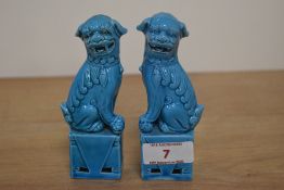 A pair of early 20th Century turquoise glazed Foo Dog statues, measuring 12cm tall