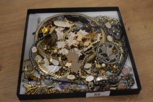 An assorted collection of vintage and enamelled costume jewellery