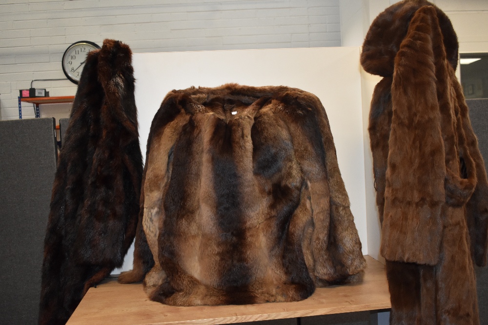 Three vintage fur coats, including mahogany toned mink coat and short rabbit fur jacket.