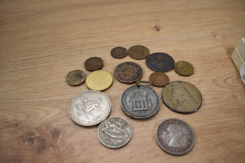 A selection of collectable coins and a commemorative Queen Victoria 60th anniversary medal.