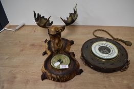 A plastic moose head barometer, measuring 48cm tall