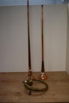 Two copper hunting horns.