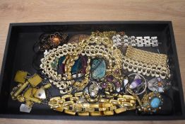 An assorted collection of costume jewellery, including a Celtic style pendant on chain, enamelled