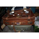 Three vintage suitcases, one having advertising stickers, including Hotel Bellevue, Fourways