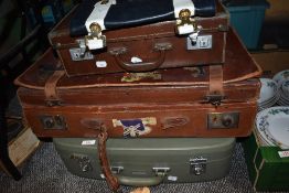 Three vintage suitcases, one having advertising stickers, including Hotel Bellevue, Fourways