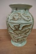 A moulded mint green Burleigh Ware vase, having Griffin and foliate decoration.