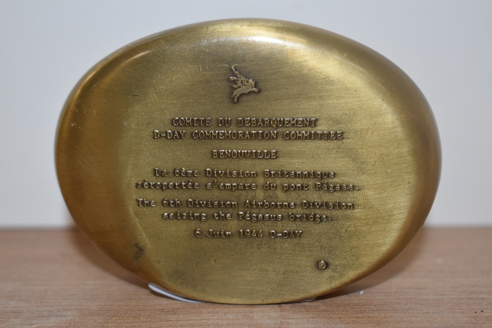 A solid brass commemorative WW2 paperweight, relief moulded to the top with a D-Day scene, inscribed - Image 2 of 2