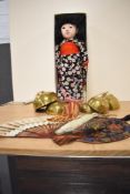 A 20th Century oriental themed costume doll and other associated items including an embroidered wall