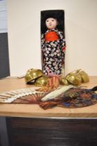 A 20th Century oriental themed costume doll and other associated items including an embroidered wall