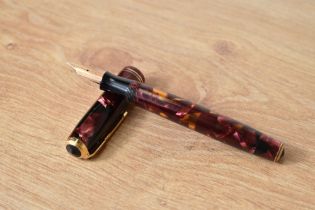 A Parker Vacumatic button fill fountain pen in rose marble and translucent barrel with two bands