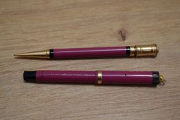 A Parker Lucky Curve Pastel button fill fountain pen and propelling pencil set in magenta with