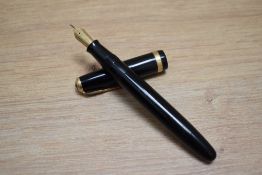 A Parker Duofold button fill fountain pen in black with decorative band to the cap having Parker