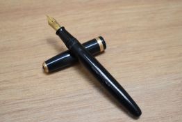A Parker Duofold button fill fountain pen in dark blue with decorative band to the cap having Parker