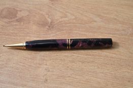 A Parker Duofold propelling pencil in burgundy and black marble. Missing top and engraved
