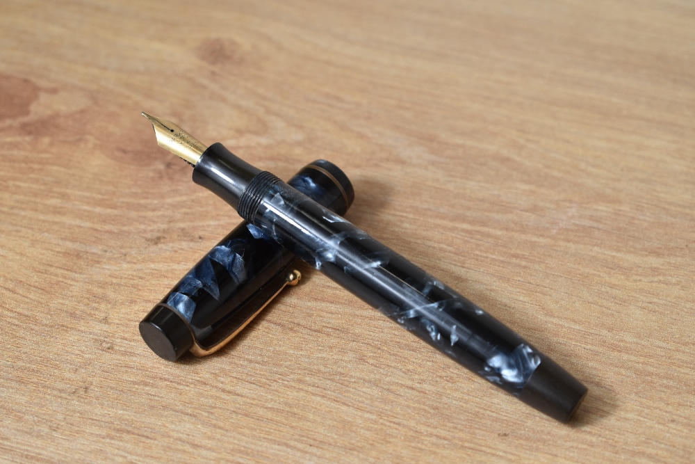 A Parker Duofold Long button fill fountain pen in blue black marble having Parker Duofold 14k N nib.