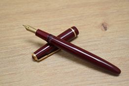 A Parker Duofold aero fill fountain pen in red with narrow decorative band to the cap having