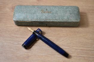 A Parker Streamlined Duofold button fill fountain pen in Lapis blue with two bands to the cap having