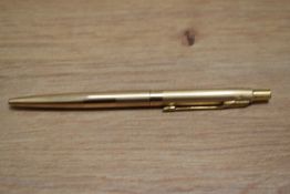 A Parker ballpoint pen in rolled gold with engine turned decal
