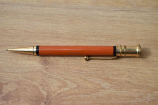 A Parker Duofold propelling pencil in red with black band to top and bottom of the barrel