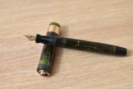 A Parker Lady Duofold Lucky Curve button fill fountain pen in mottled green with broad band to a