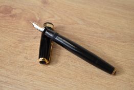 A Parker Vacumatic button fill fountain pen in black with broad decorative band to cap having Parker