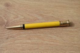 A Parker Duofold propelling pencil in manderin yellow, slight damage to gold top and light crack