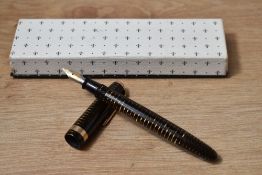 A Parker Vacumatic fountain pen in golden brown with broad band to the cap and blue diamond clip