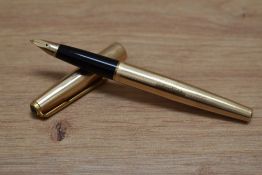 A Parker 65 aero fill fountain pen in rolled gold having Parker 14k nib. Engraved and dent to