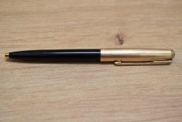 A Parker 65 ballpoint pen in black with rolled gold cap