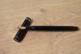 A Parker Lucky Curve button fill fountain pen in black with two bands to the cap having Parker 14K