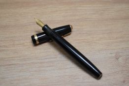 A Parker Duofold button fill fountain pen in black with decorative band to the cap having Parker