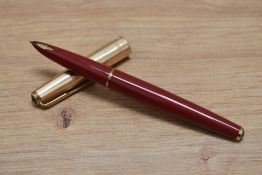A Parker 65 capillary fill fountain pen in red with rolled gold cap. Boxed