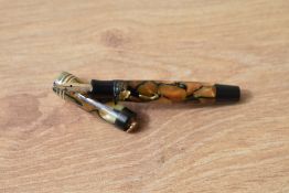 A Parker Vest Pocket Duofold button fill fountain pen in pearl and black with one broad and two