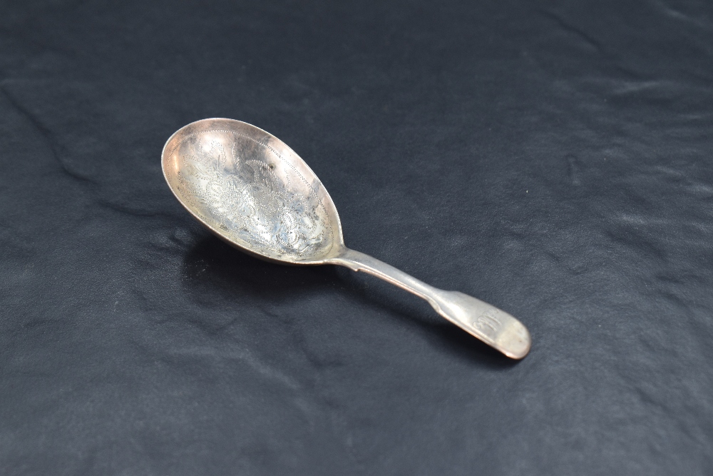 A Victorian silver fiddle pattern caddy spoon, the oval bowl with foliate bright-cut engraving,