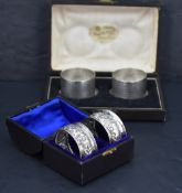 A pair of late Victorian silver napkin rings, of cylindrical form with engine-turned decoration