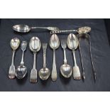 A group of mixed silver spoons and sugar tongs, George III and later, three with well executed