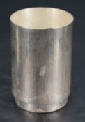 A Queen Elizabeth II silver beaker, of planished cylindrical form with short circular foot, marks