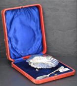 A late Victorian cased silver scallop-shell form butter dish with near matching butter knife (