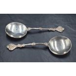 A pair of Edwardian silver trefoil spoons, of medieval design the the shallow circular bowls with