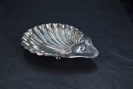 An Edwardian silver scallop-shell form butter dish, with marks for Sheffield 1904, maker James