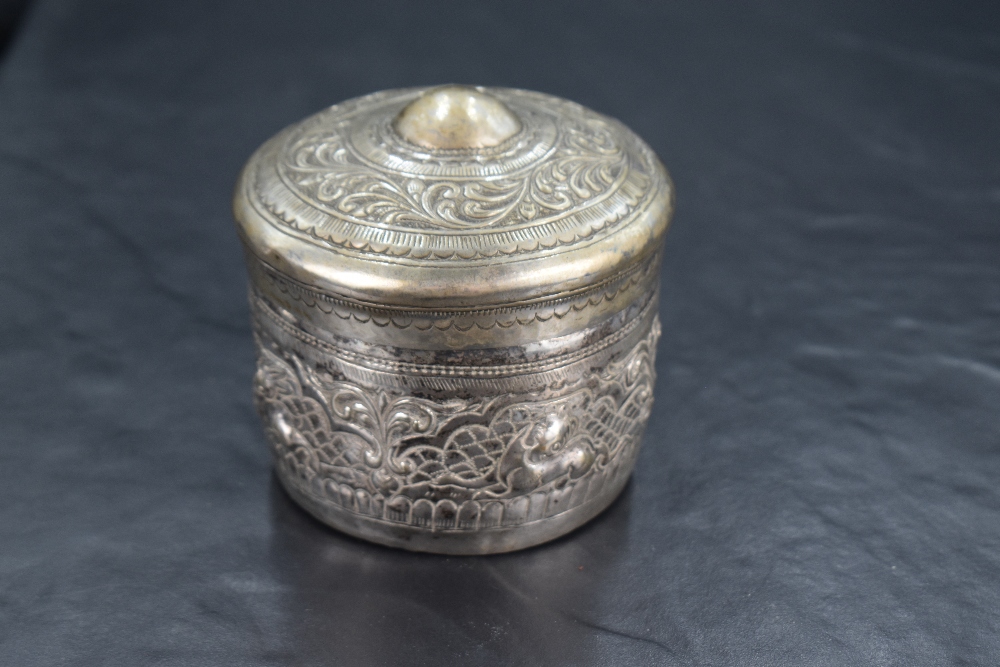 A late 19th/early 20th century eastern white metal box, of hinged cylindrical form, the slightly