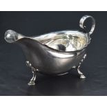 An Edwardian silver gravy boat, of traditional design, having a short flared rim, generous spout and