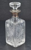 A Queen Elizabeth II silver mounted cut-crystal decanter, of square outline with circular star-cut