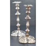 A pair of Edwardian silver candlesticks, of 18th century design with removable sconces and resting