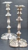 A pair of Edwardian silver candlesticks, of 18th century design with removable sconces and resting