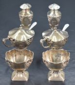 A George V silver six piece condiment set, comprising two salts, two pepperettes and two mustards,
