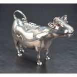 A fine Victorian silver cow creamer, of stylised form with inset red glass eyes, slightly opened