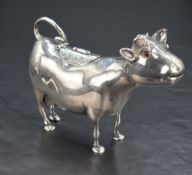 A fine Victorian silver cow creamer, of stylised form with inset red glass eyes, slightly opened