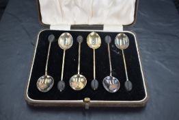 A cased set of six George V silver and guilloche enamel coffee bean spoons, of traditional form, the